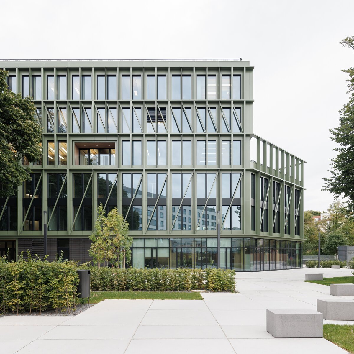 Außenansicht des Interhyp-Büros in München mit gläserner Fassade und Grünfläche; im Inneren verbaute Lindner Raum-in-Raum-Systeme. | © © Nikolay Kazakov